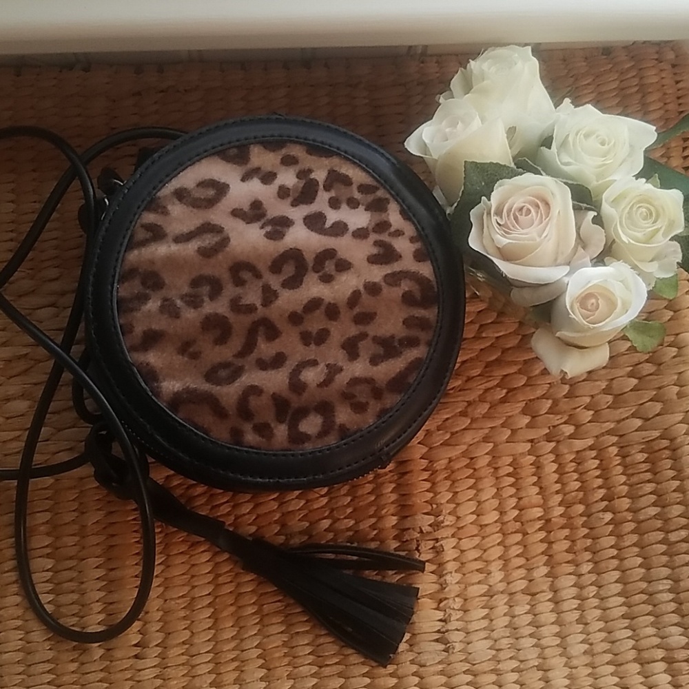 Black faux leather circular shaped crossbody